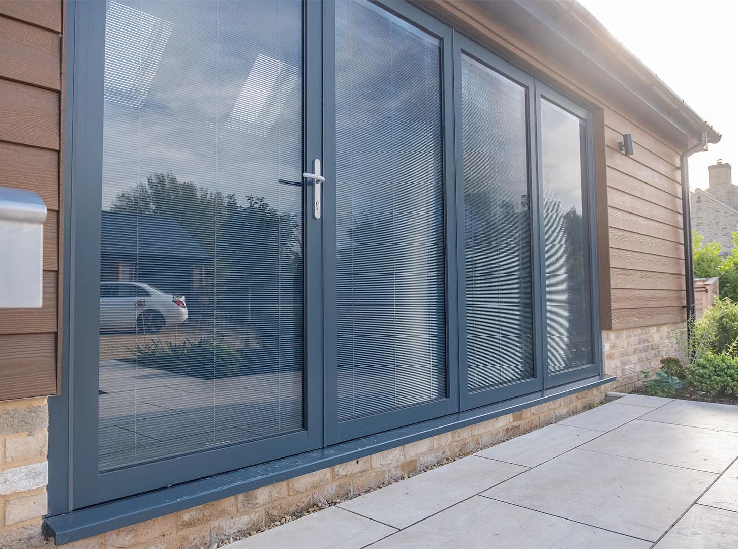 Dark framed glazed doors with integral blinds sealed inside the glass units