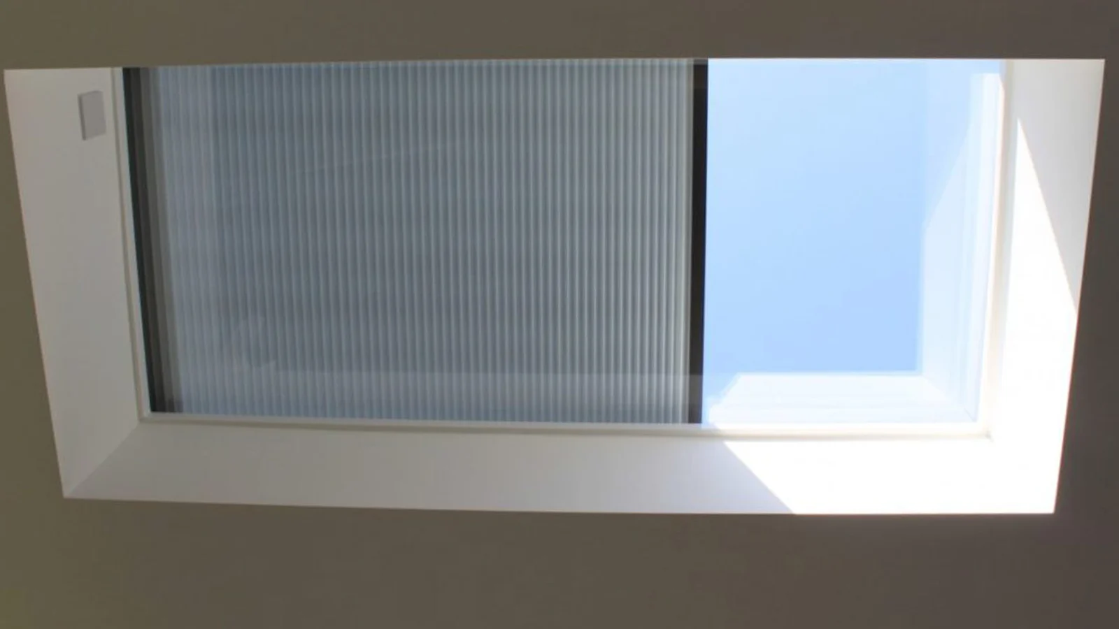 Close-up of an integrated blind inside a flat rooflight unit