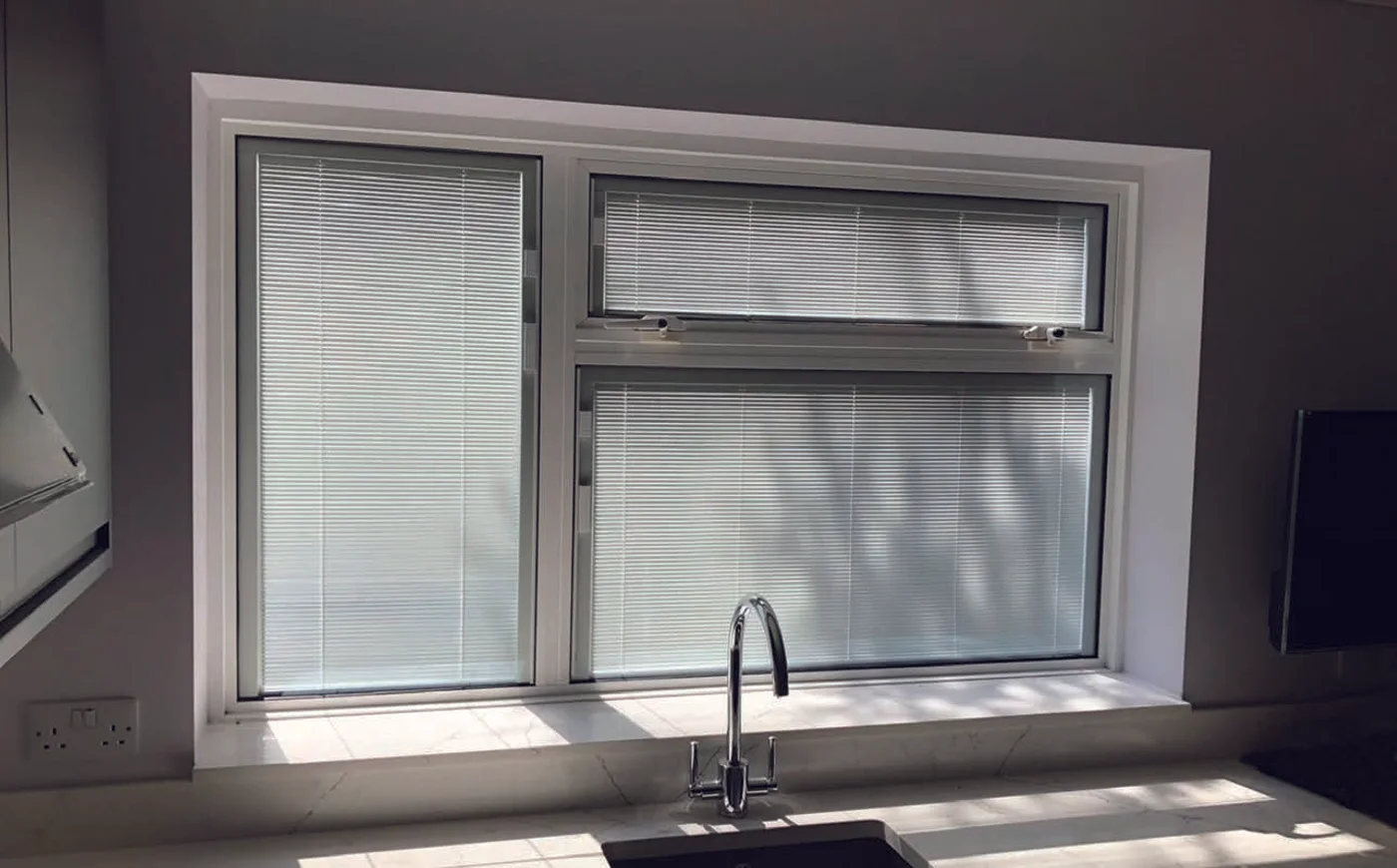 Window with integral blinds inside the glazed units for selective privacy control
