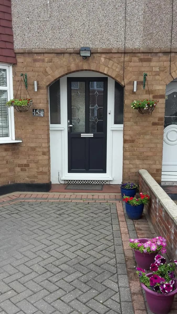Anthracite composite front door installed with brickwork and entrance detail