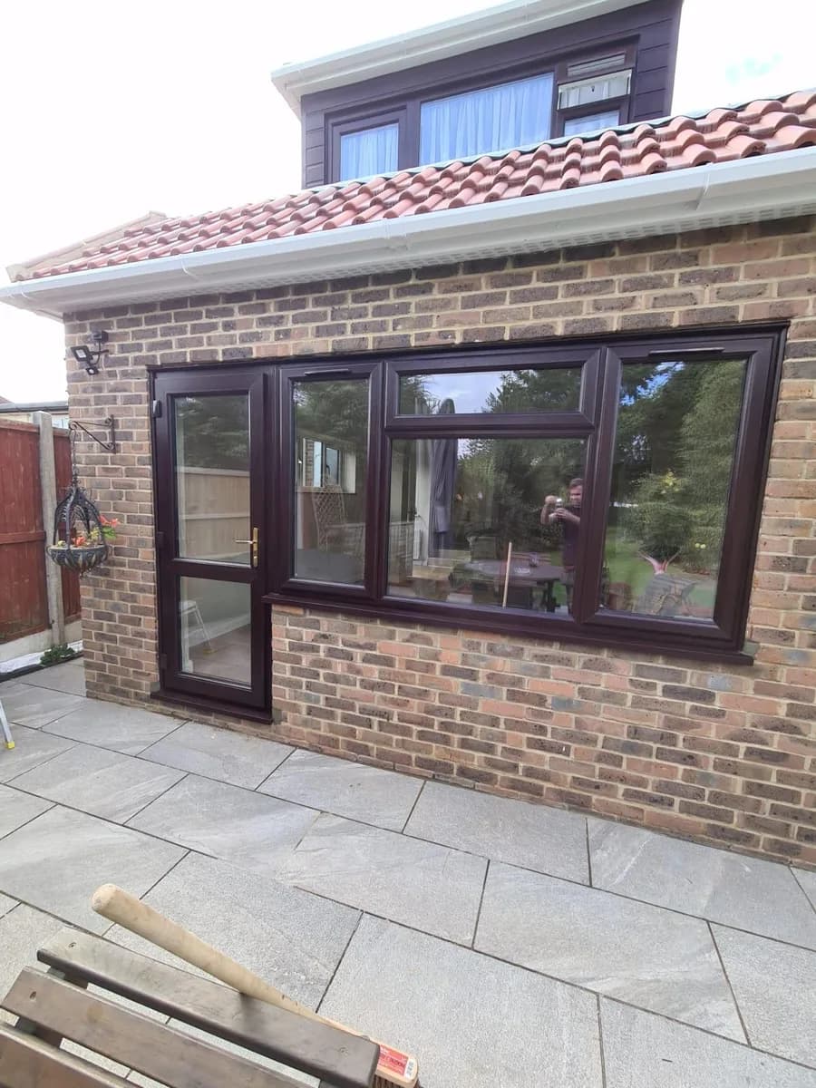 Wide view of rosewood uPVC casement windows installed across a Chigwell house frontage