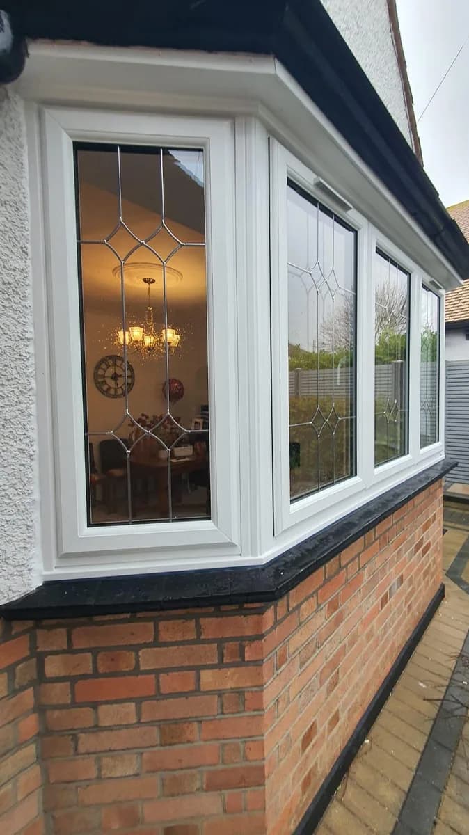 Side return of a white uPVC casement bay window with leaded glass installed in Romford by Cii Double Glazing