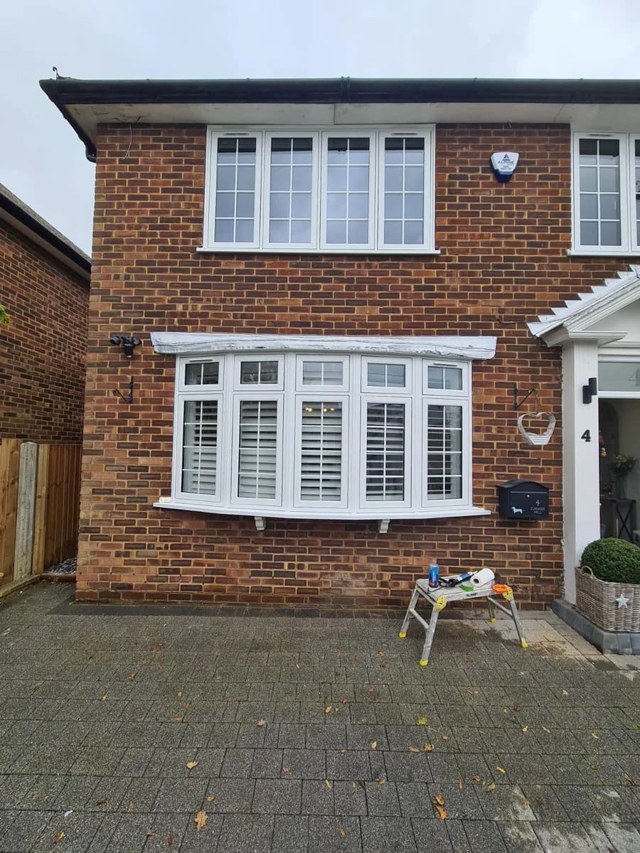 White replacement windows installed across the front of a house