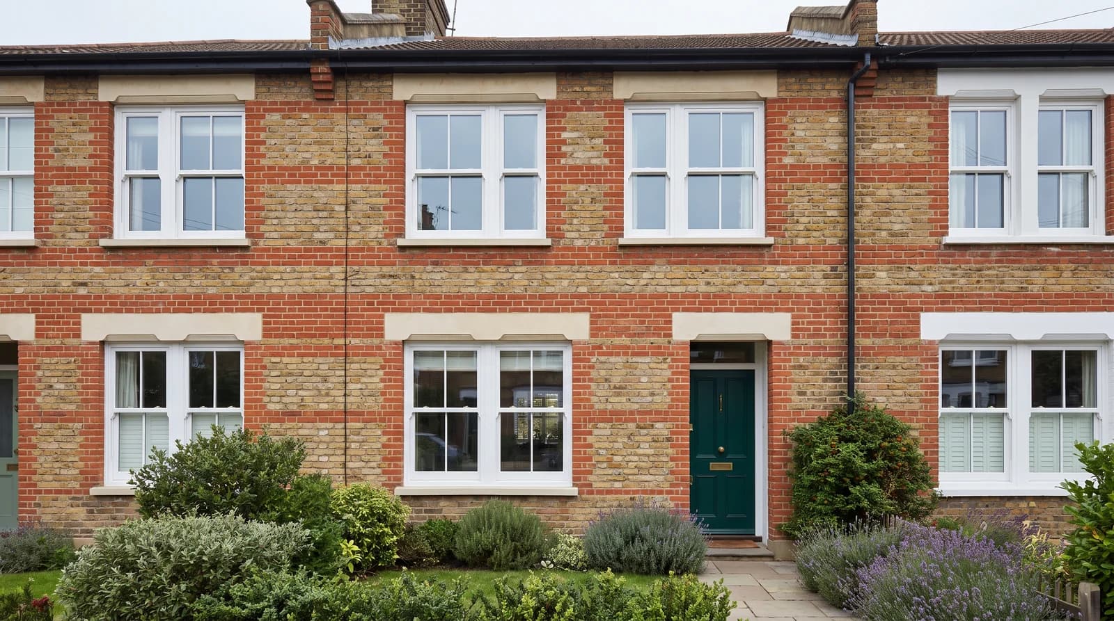 White uPVC sash horn windows on a Victorian red-brick terrace, by Cii Double Glazing